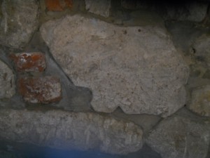 Reused stone in inside wall filling in jettied first floor